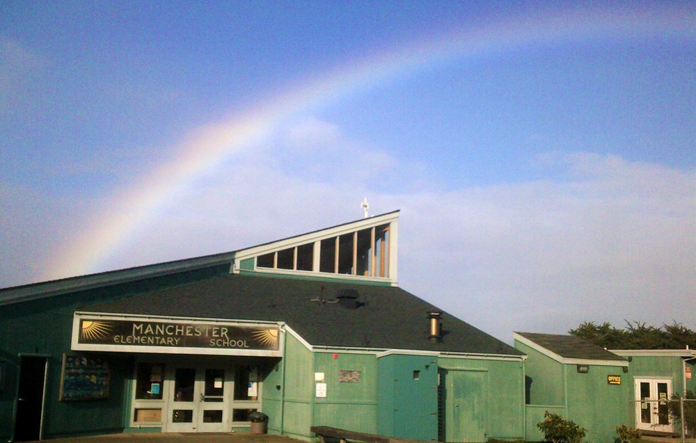 Rainbow ending on Manchester Elementary School building.